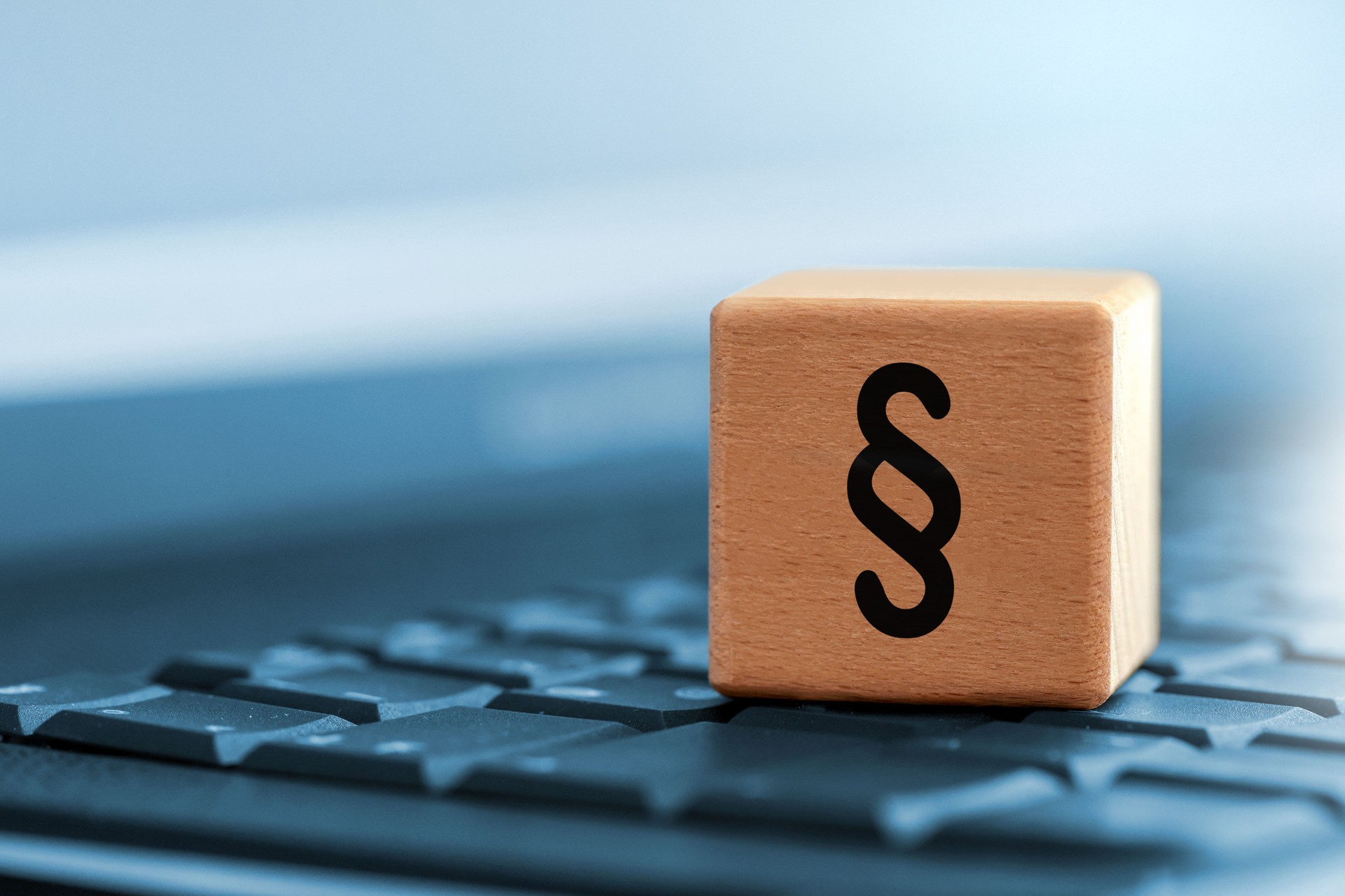Close up of paragraph character on wooden block on computer keyboard